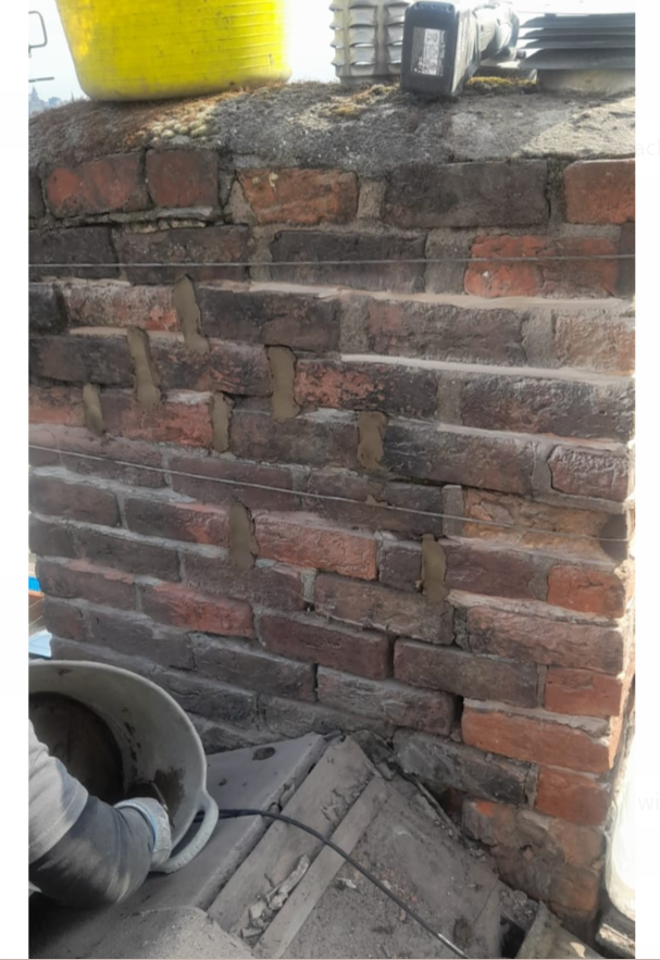 Brick chimney repair with lead flashing